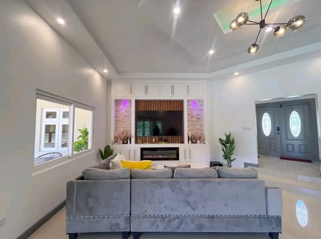 Living-area-with-TV-and-fireplace.webp